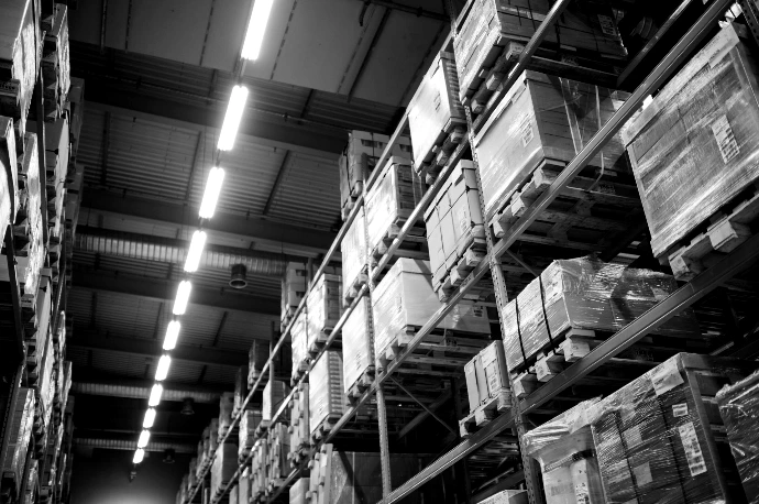 brown cardboard boxes on white metal rack